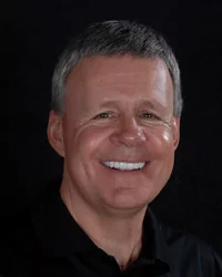 Man showing off his shiny new porcelain crowns in Fallbrook.